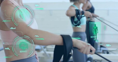 Women strapping forearm loops on reformers and pulling cables displaying fitness biometric overlays - Powered by Adobe