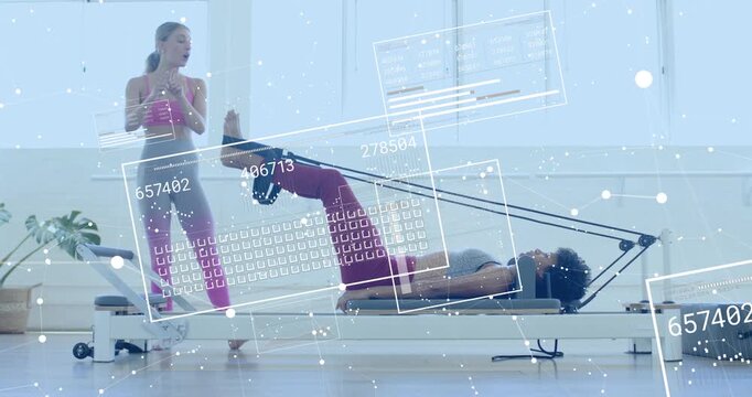 Instructor guiding leg press client pressing carriage outward extending legs for Pilates alignment