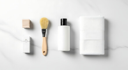 Naklejka premium Minimalist flat lay of bathroom essentials on a white marble background