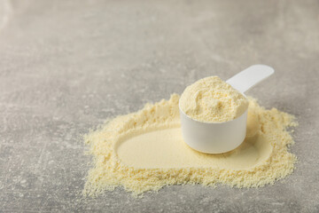 Protein powder. A spoonful of protein powder on a table. Different flavors of whey protein powder. Sports nutrition concept. Gym. Amino acid food supplement, creatine powder. Copy space.