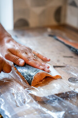 Fresh salmon fillet being prepared by hand on wooden cutting board in kitchen