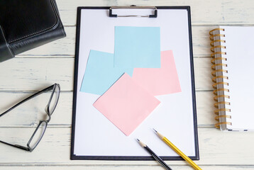 Blank sheet tablet, colored post-it notes, pen. Calculator