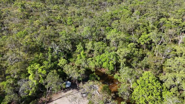 aerial drone shot of a beautiful rainforest landscape along the old telegraph track at the iconic Bertie Creek river crossing in tropical north Queensland of Cape York, Australia.