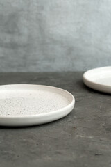 White dinner plates for main courses on a gray background
