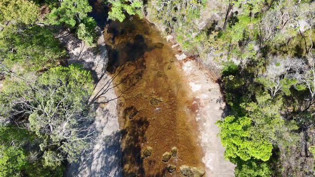 aerial drone shot of a beautiful rainforest landscape along the old telegraph track at the iconic Bertie Creek river crossing in tropical north Queensland of Cape York, Australia.
