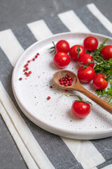 Cheesecakes with different berries on a light plate on a gray table