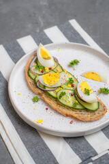 Cheesecakes with different berries on a light plate on a gray table
