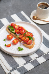 Cheesecakes with different berries on a light plate on a gray table