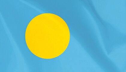 Palau national flag with light blue field and large yellow circle slightly offset toward hoist side.