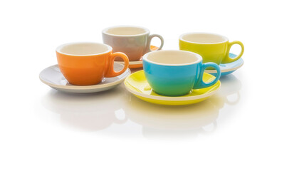 Set of colorful porcelain coffee cups and saucers on a white background. Horizontal imagen. Copy space.