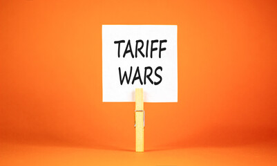 Trade tariff wars symbol. Concept word Tariff wars on beautiful white paper. Beautiful wooden...