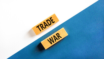 Trade war symbol. Concept word Trade war on beautiful wooden blocks. Beautiful white and blue paper...