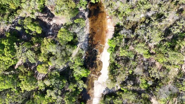 aerial drone shot of a beautiful rainforest landscape along the old telegraph track at the iconic Bertie Creek river crossing in tropical north Queensland of Cape York, Australia.