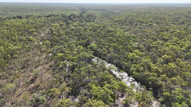 aerial drone shot of a beautiful rainforest landscape along the old telegraph track at the iconic Bertie Creek river crossing in tropical north Queensland of Cape York, Australia.