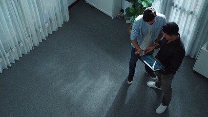 Top view of business man stand with investor while holding tablet and looking at financial...