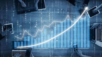 A dynamic business meeting scene showcasing hands collaborating to analyze financial growth data on digital devices, highlighting teamwork in a modern office setting. Copula