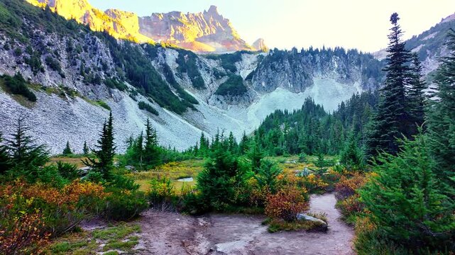 Scenic view of the Bench and Snow Lakes trail with brilliant red and orange fall foliage under a clear sky in Mount Rainier National Park
