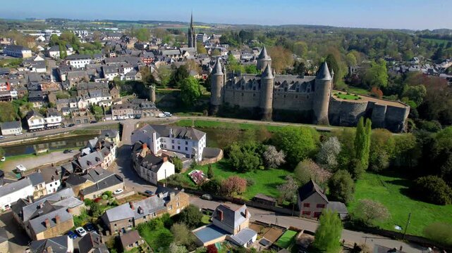 4K cinematic drone footage of Chateau de Josselin and the Oust river, majestic medieval fortress with Renaissance architecture, historic old town in Morbihan, Brittany, France.