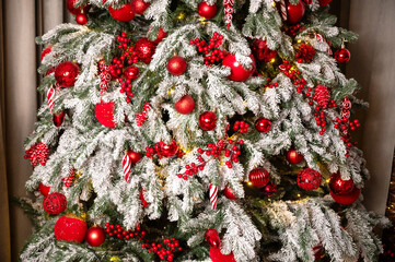Close-up of Luxurious Christmas Tree Decoration with Red Baubles and Festive Lights