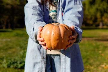 woman holding halloween pumpkin