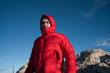 Man wearing red jacket hiking teide volcano peak