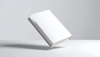 Fototapeta premium Minimalist White Book Cover Mockup Floating in Studio Lighting for Novel or Textbook Design Presentation