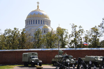 military equipment and view of St. Nicholas Cathedral in Kronstadt view from the park