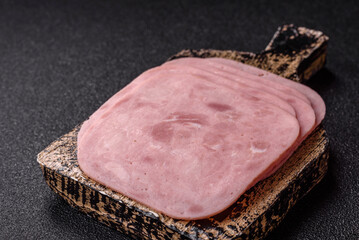 Meat, square ham sliced, organic food, protein for snacks. Sliced ham as a background © chernikovatv