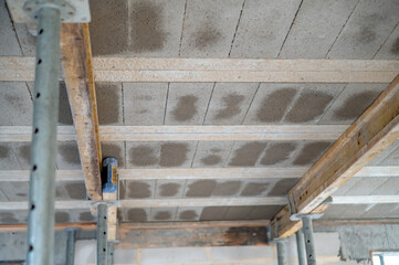 Construction process: installation of beam-and-block floor system on prestressed beams. Bottom view. Concept of strength, engineering precision, and technology.