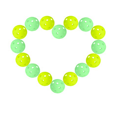 Heart shaped pattern made of green and yellow pickleballs balls on transparent background.
