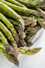 Fresh green asparagus spears are beautifully arranged on a plate, highlighting their flavor
