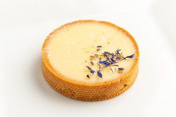 A beautifully crafted tart features a smooth cream filling topped with lavender blossoms