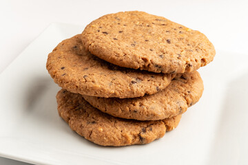 Freshly baked cookies in a stack offer a tempting treat for any dessert lover's cravings