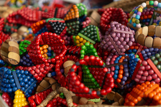 Pile of colorful wooden beaded and carved bracelets for mass market sale in a souvenir store or craft stall concept of tourist souvenir, local craftsmanship, retail products