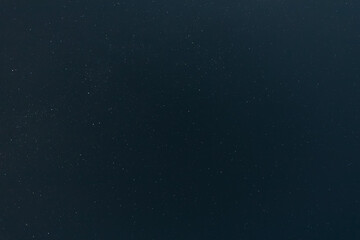 A calm, clear night sky filled with countless tiny stars, fading gently toward the horizon in a serene and peaceful celestial view.