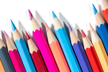 Macro shot of vivid colored pencils on transparent background with shadows. Artistic supplies for design, drawing and creativity projects.