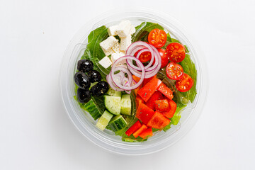 A vibrant salad bowl brimming with fresh greens, juicy tomatoes, crunchy cucumbers, and feta cheese