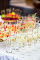 Sparkling glasses are filled with bubbly drinks, surrounded by a colorful array of tasty appetizers