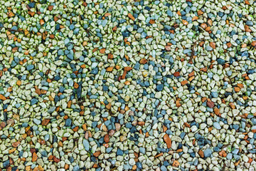 A path paved with small colored pebbles. Texture