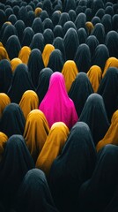 Obraz premium Vibrant Individuality: A Pink Figure Standing Out Among a Sea of Dark and Yellow Cloaks