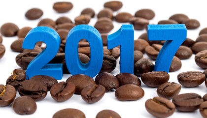 A close-up photo features the blue wooden numbers "2017" positioned among a bed of roasted coffee beans, all on a white background
