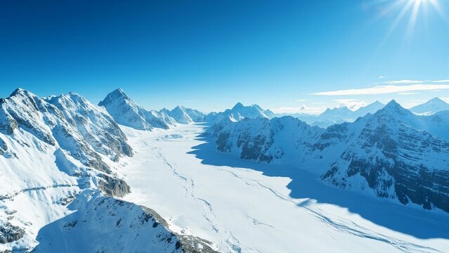 Snowy mountain winter sunny landscape view from above