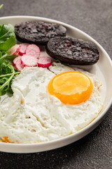 Eggs breakfast black pudding, egg, vegetables, arugula portion size natural product tasty snack fresh delicious gourmet food background on the table rustic top view copy space