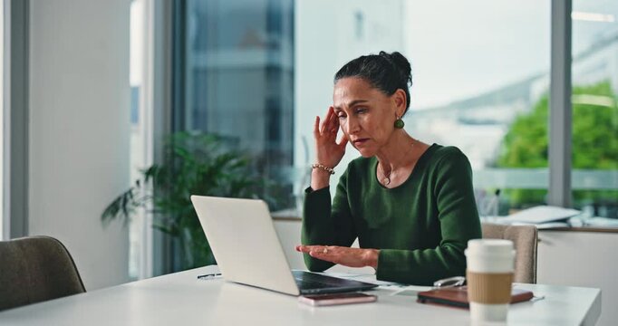 Mature woman, headache and laptop at office with finance, stress or frustrated for lost profit at company. Person, broker or advisor with migraine, computer or burnout for review at investment agency