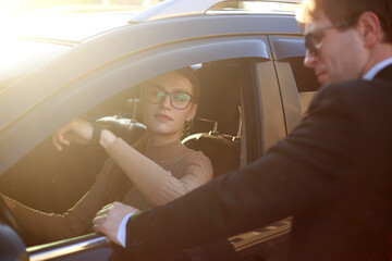 Corporate meeting of two employees in car for work and discussion of business