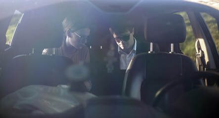 Corporate meeting of two employees in car for work and discussion of business