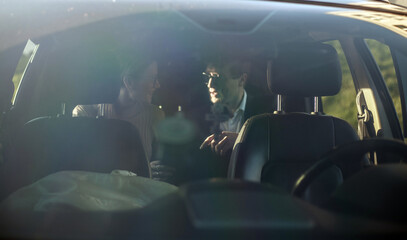 Corporate meeting of two employees in car for work and discussion of business
