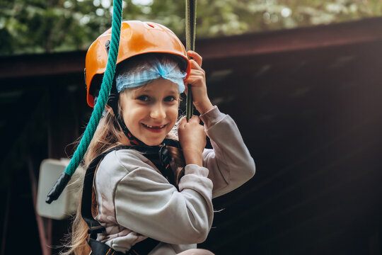 Child Laughing on Zip Line Adventure in Park