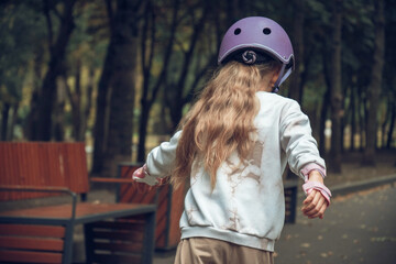 Girl Skateboarding in Park with Helmet and Gloves