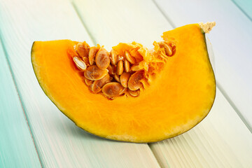 sliced grey pumpkin on wood background